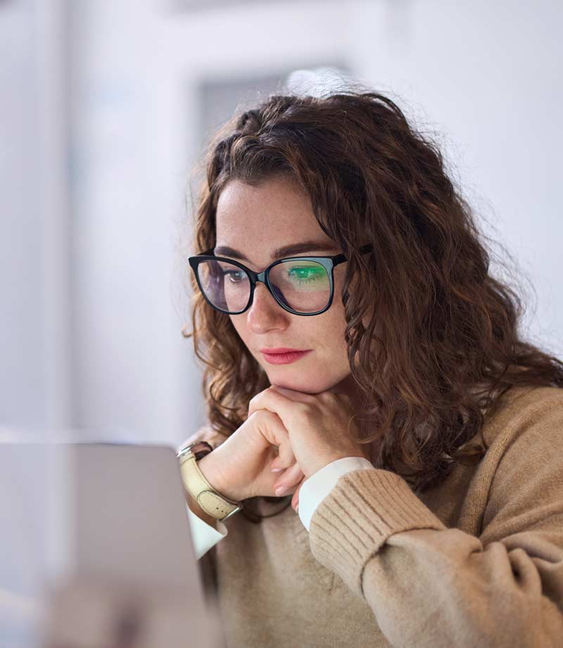</p>
<p>Search by image or video<br />
Young woman worker wearing glasses watching online
